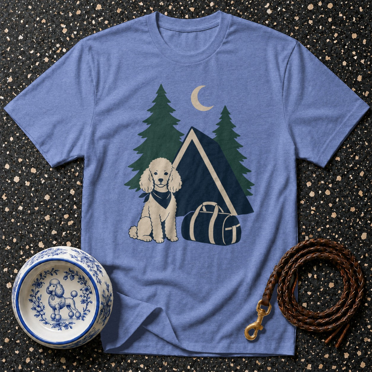 Light blue t-shirt with a cartoon poodle, tent, trees, and moon graphic.