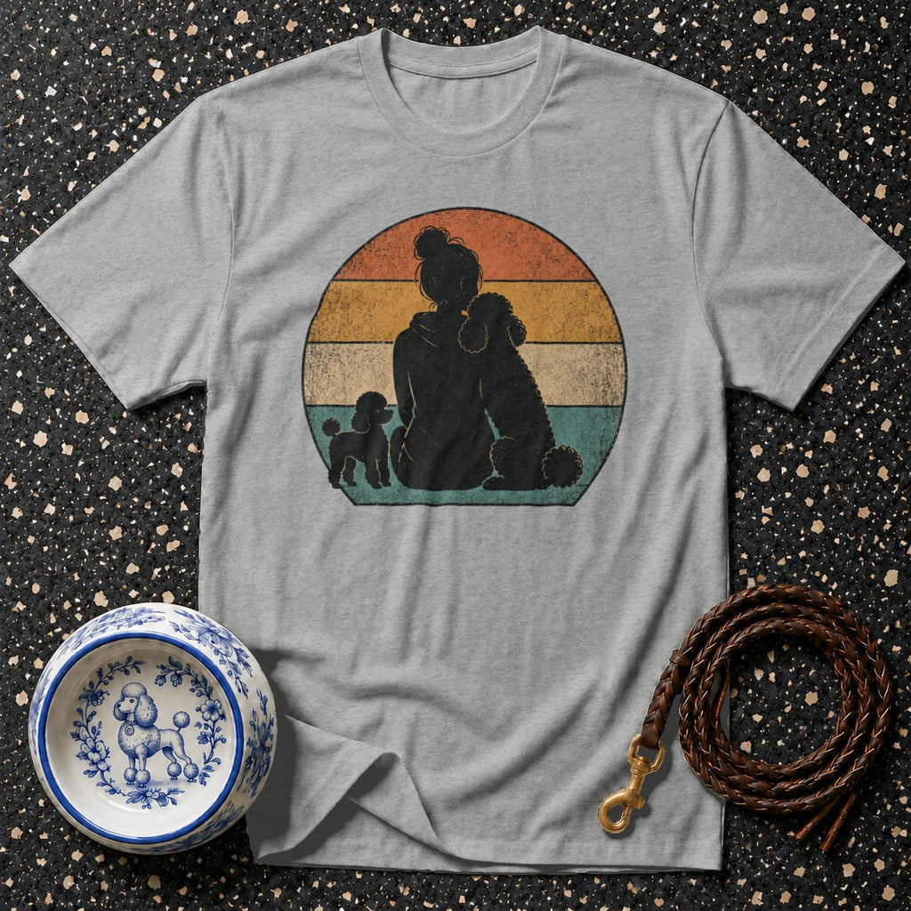 Grey t-shirt with retro graphic of person and poodles against striped circle.