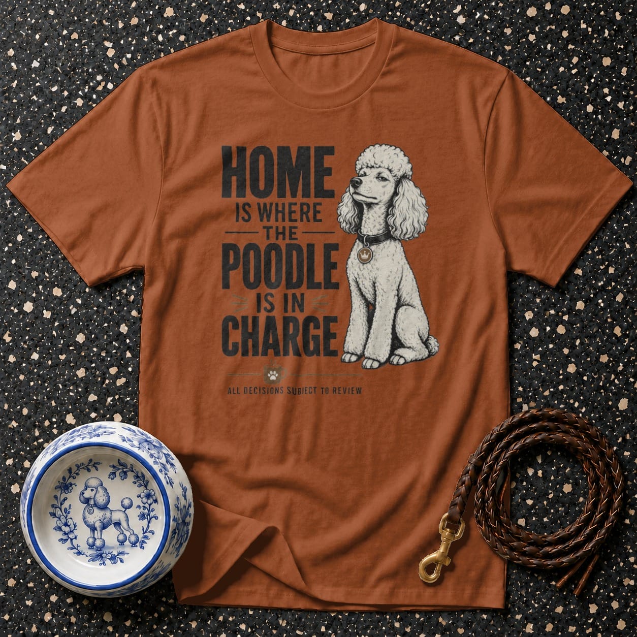Brown t-shirt with text "HOME IS WHERE THE POODLE IS IN CHARGE" and a poodle illustration.