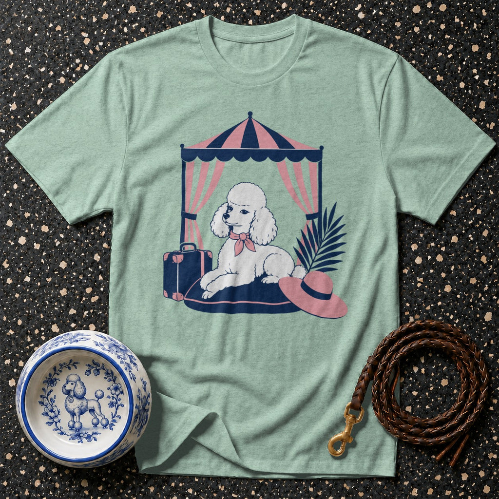 Poodle illustration on a mint green t-shirt under a striped tent.