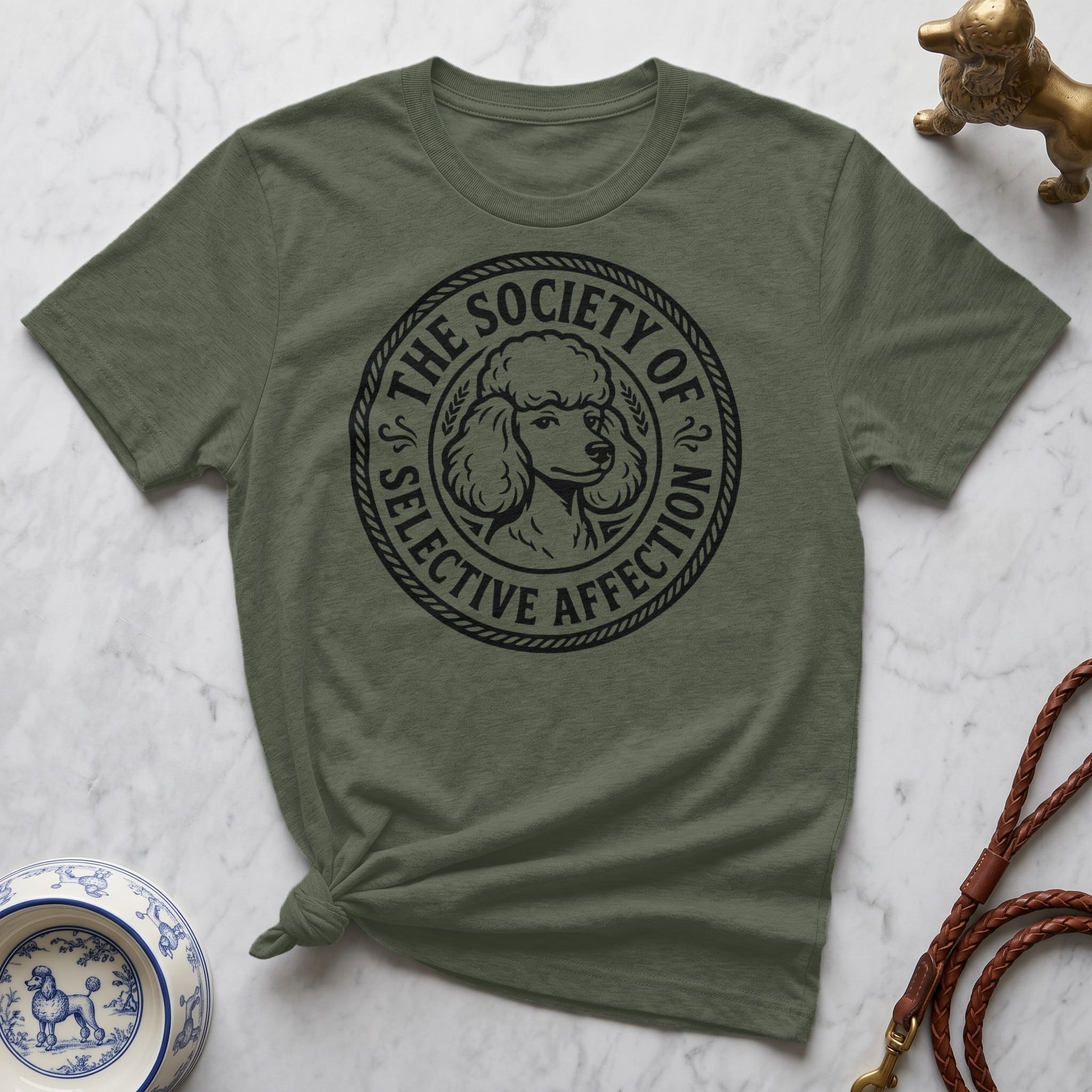 Olive green t-shirt with a black circular graphic of a poodle and the text "THE SOCIETY OF SELECTIVE AFFECTION".