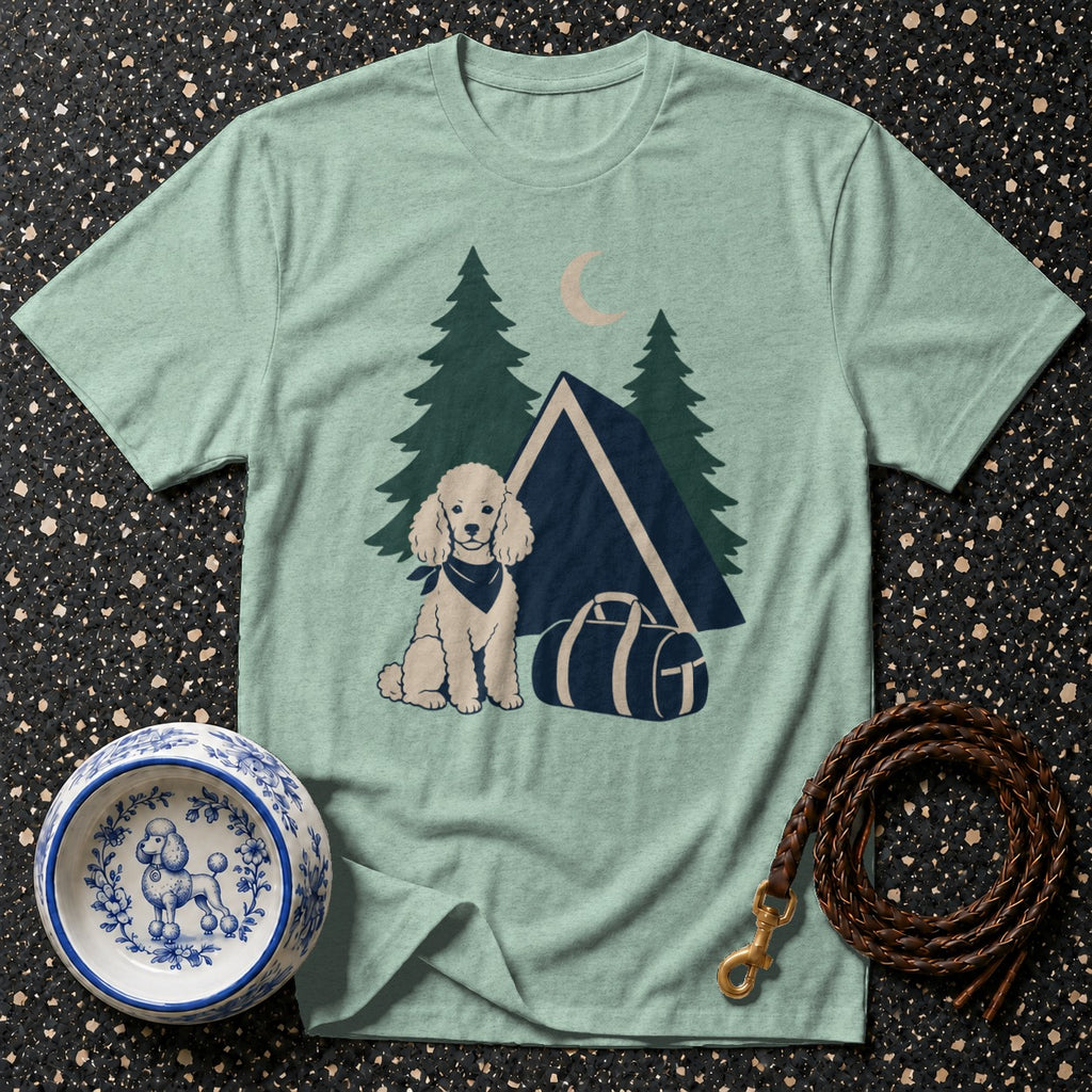 Light blue t-shirt with cartoon poodle, tent, trees, and duffel bag design.